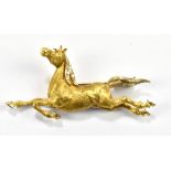 A yellow and white metal brooch in the form of a horse, with three melee diamonds set to mane,