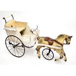 A 19th century wooden pram modelled in the form of a horse and cart, raised on three wheels,