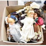 A large group of modern bisque headed dolls with wigs, glass eyes, painted features and closed