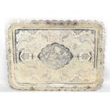 An Eastern white metal tray with shaped border and main panel decorated with animals, birds and