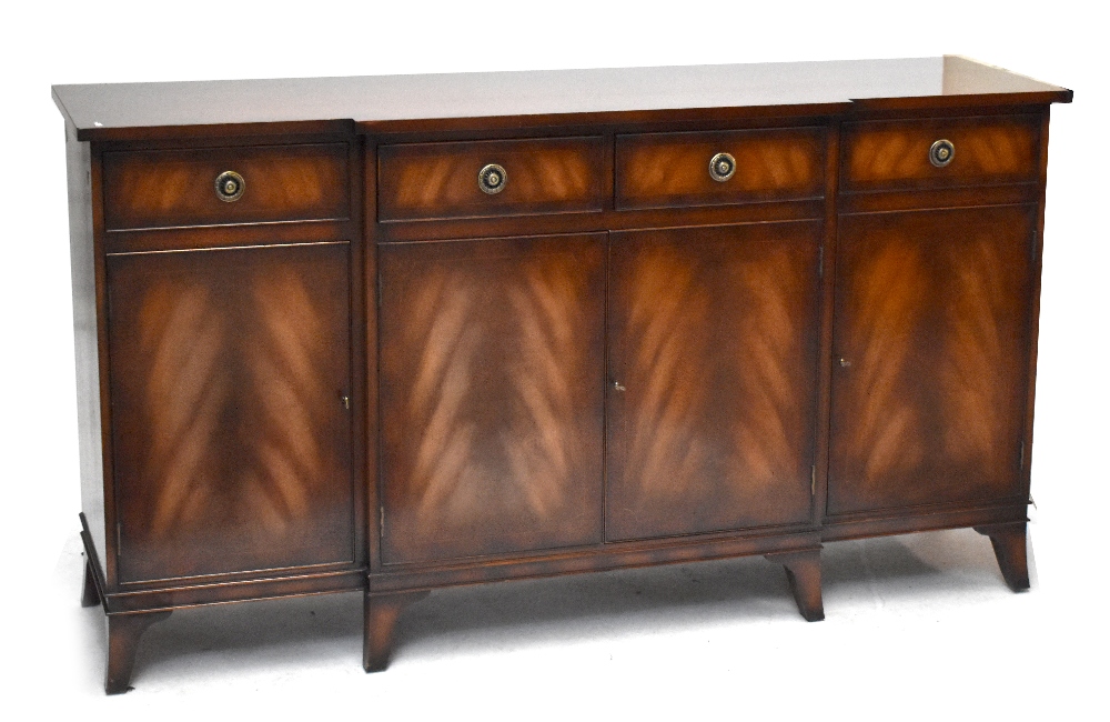 A reproduction mahogany breakfront sideboard with four drawers above four panelled cupboard doors,