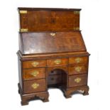 An early 18th century burr yew wood and walnut crossbanded cabinet of excellent colour, the upper