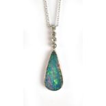 An opal and diamond pendant suspended on fine link white metal chain, the tear shaped opal set