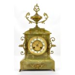 An early 20th century onyx mantel clock, with gilt metal applied urn finial and handles, the