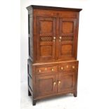 A mid-19th century oak bread and cheese cupboard, circa 1820-1840, with two panelled doors with