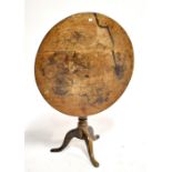 A George III oak tilt top tripod table, diameter 77cm.Additional InformationTop heavily worn,