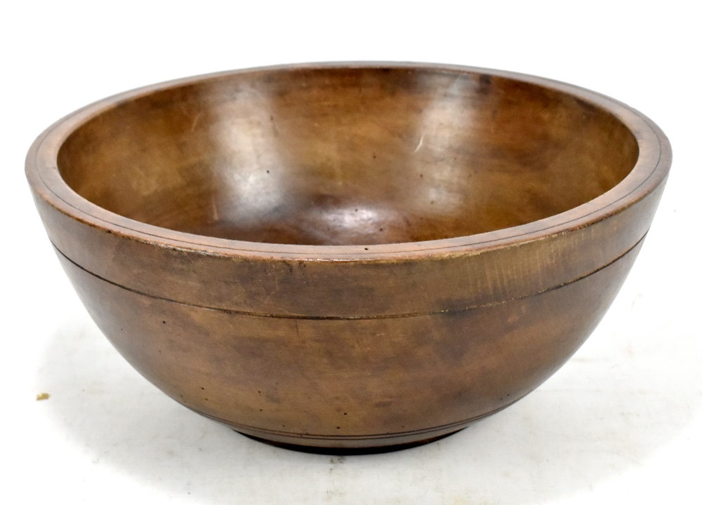 A 19th century stained beech Welsh dairy bowl, diameter 39cm.