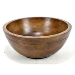 A 19th century stained beech Welsh dairy bowl, diameter 39cm.