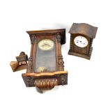 An oak mantel clock, the circular dial set with Roman numerals, and a wall clock (af) (2).