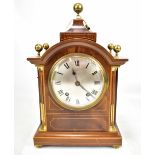 An Edwardian inlaid mahogany and boxwood strung mantel clock, the silvered dial set with Roman