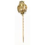 A 14ct gold stick pin, with crown finial above pierced decoration, bears impressed marks to pin