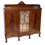 An early 20th century mahogany break front book case/display cabinet, raised on ball and claw