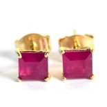 A pair of 9ct yellow gold ruby ear studs, the princess cut rubies each weighing approx 0.5cts,