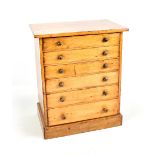A stained pine six drawer collectors' cabinet on plinth base, height 46cm.Additional