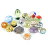 A collection of sixteen glass paperweights, to include millefiori and advertising examples, also a