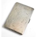 A George VI hallmarked silver cigarette case of rounded rectangular form with engine turned