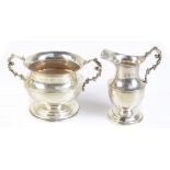 TH HAZELWOOD & CO; an Edward VII hallmarked silver milk jug and sugar bowl each with cast handles,