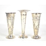 JACKSON & FULLERTON; a pair of late Victorian hallmarked silver floral embossed tapering vases,