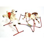 Two vintage painted horses on springs to red painted stands, height of taller approx 90cm (2).
