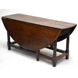 An 18th century oak drop leaf table with single drawer, length 164cm.