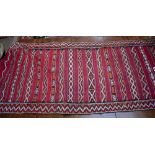 A Moroccan floor rug with stylised geometric decoration.Additional InformationVintage hand loomed