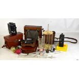 A group of early 20th century camera equipment, a cine camera, a pathoscope in leather case, etc.