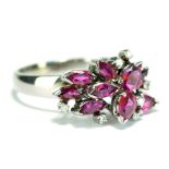 A white metal marquise cut ruby and diamond set spray cluster ring, ruby approx 2.4cts, band stamped