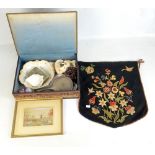 An embroidered box and contents including a hand mirror, bowl, figure, needle work picture, etc.