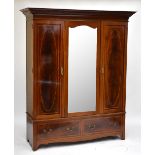 An Edwardian inlaid crossbanded mahogany triple door wardrobe, the central door with mirrored