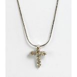 A white metal and diamond cross pendant with ten graduated round cut stones, stamped to back 750, on