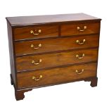 An early 19th century chest of two short over three long drawers on bracket feet.