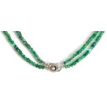 A rough cut emerald bead two string necklace with white metal diamond set clasp, length approx 38cm,