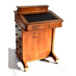 A late Victorian walnut and inlaid Davenport with four side drawers, width 53cm.