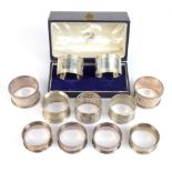 Eleven variously hallmarked silver napkin rings, some cased, combined approx 7ozt.