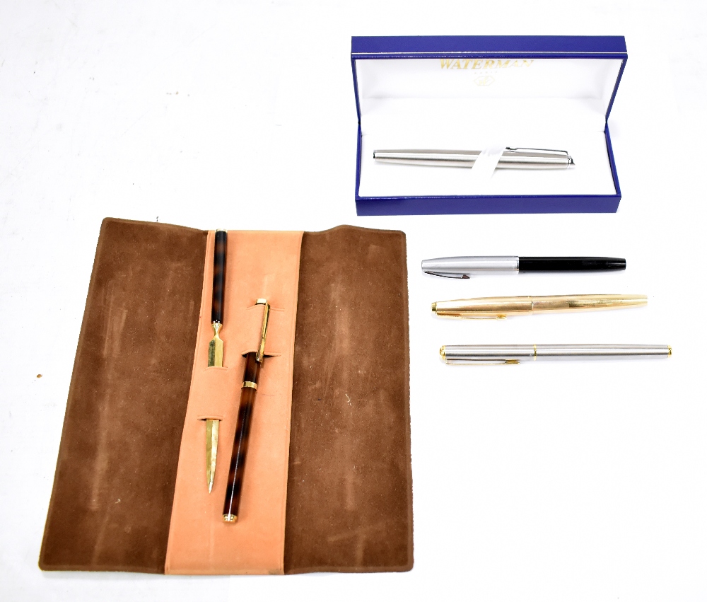 WATERMAN; a boxed ballpoint pen with silvered finish and three fountain pens by Parker, Sheaffer and