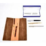 WATERMAN; a boxed ballpoint pen with silvered finish and three fountain pens by Parker, Sheaffer and