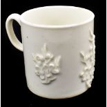 BOW; an 18th century blanc de chine coffee can with applied prunus decoration, height 5.75cm.