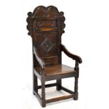 A late 17th century Yorkshire Wainscot chair with scrolling arched top rail above lozenge carved
