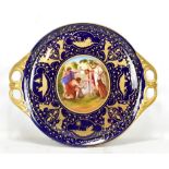 VIENNA PORCELAIN; a twin handled circular tray with central panel depicting figures in landscape