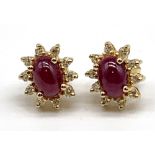 A pair of 18ct cabochon ruby and diamond set floral ear studs, each platform approx 11mm x 9mm,