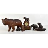 Six Black Forest carved wooden bears to include a figural clock, height 17cm, a desk blotter, etc (