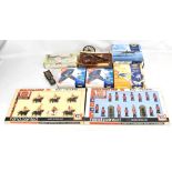 A small group of military themed toys and models, including two boxed sets of Britain's soldiers,