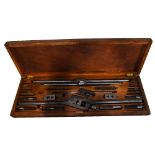 A metal tap and die set in a stained wooden case, length 97cm.