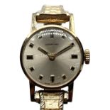 GARRARD; a lady's vintage 9ct yellow gold wristwatch, the circular dial set with baton markers and