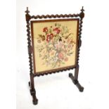 A 19th century mahogany and rosewood framed fire screen with rotating tapestry and silk panel,