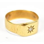 An 18ct yellow gold signet ring, with central diamond stone, size T/U, approx 4.9g.