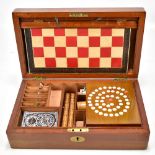 A late 19th/early 20th century mahogany games box, the hinged cover enclosing various games to