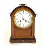 An Edwardian mahogany brass inlaid mantel clock, the circular dial set with Roman numerals, height