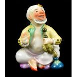 MEISSEN; a 20th century figure of a seated smoking Turk, designed by Paul Scheurich, painted blue