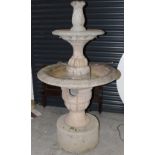 A large stoneware circular two-tier garden fountain in the Classical style, on a circular base,